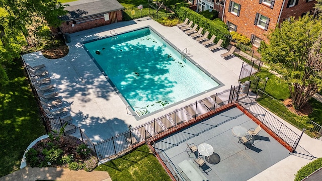 pool featuring fence and a patio area