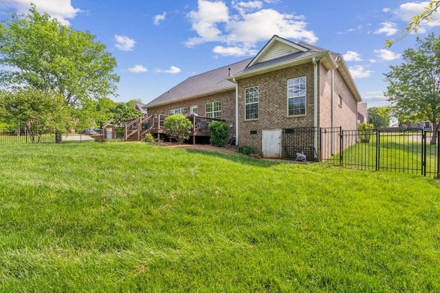 view of property exterior featuring a yard, brick siding, fence, and a wooden deck