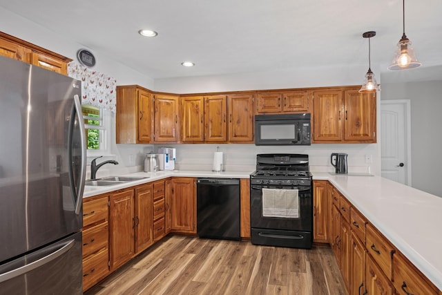606 Fortner Rd, Mc Ewen, TN 37101 - kitchen featuring light countertops, light wood-type flooring, black appliances, and brown cabinets