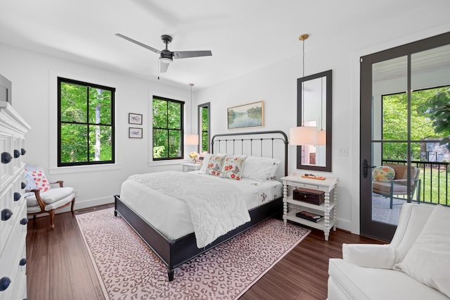 bedroom featuring baseboards, a ceiling fan, dark wood-style flooring, and access to exterior