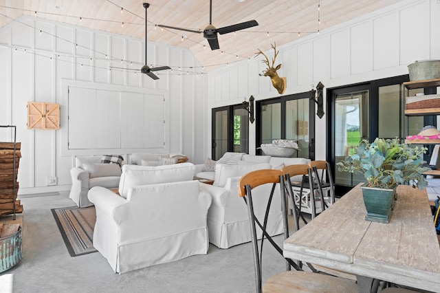 interior space with a ceiling fan, high vaulted ceiling, concrete flooring, and a wealth of natural light