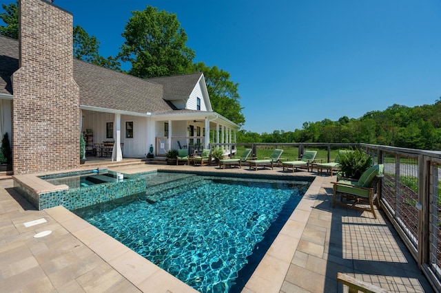 view of pool featuring a patio, a pool with connected hot tub, and ceiling fan