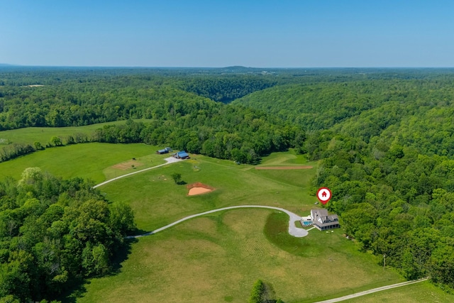 drone / aerial view featuring a forest view