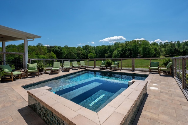 view of swimming pool with a fenced in pool, a patio, an in ground hot tub, and a forest view