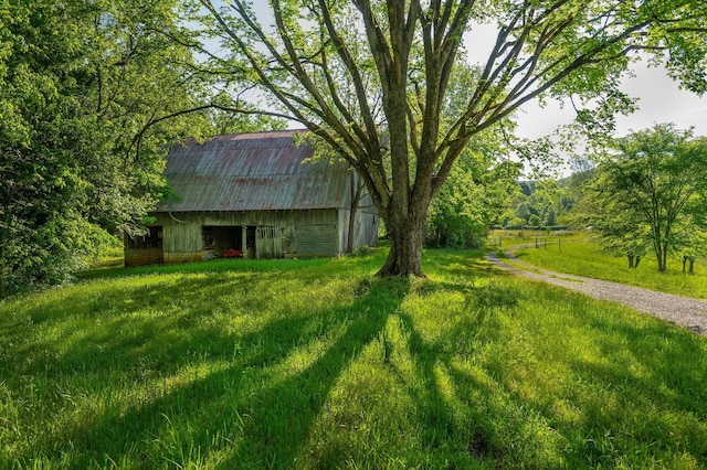 view of yard with a barn and an outbuilding