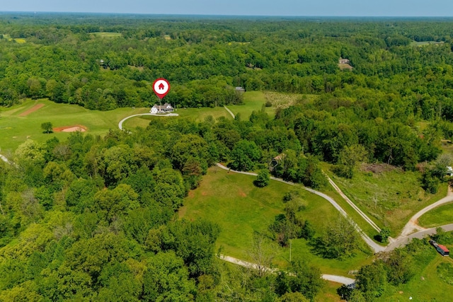birds eye view of property featuring a forest view