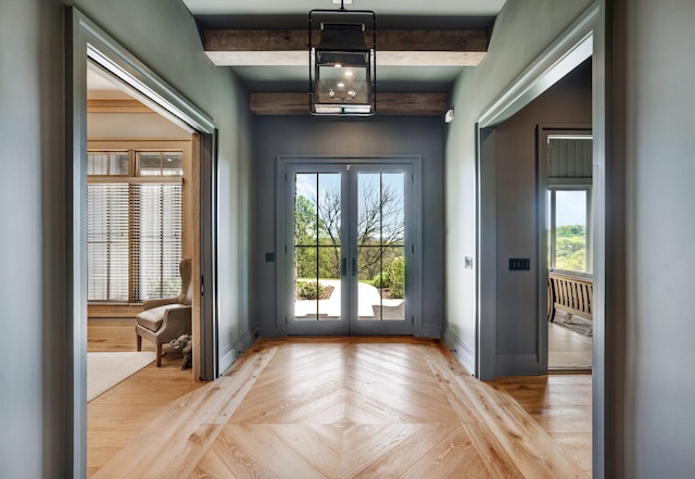 doorway to outside with french doors, baseboards, a healthy amount of sunlight, and beamed ceiling