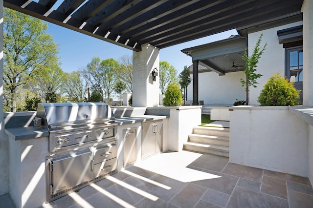 view of patio featuring area for grilling, ceiling fan, and a grill