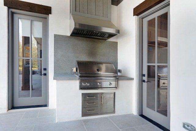 view of patio / terrace with exterior kitchen and a grill