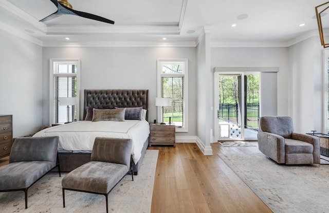bedroom featuring access to outside, baseboards, multiple windows, and light wood-style flooring