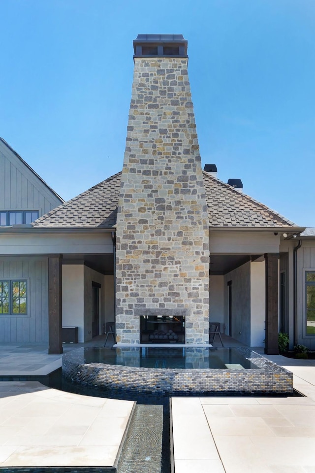 view of patio / terrace featuring a glass covered fireplace