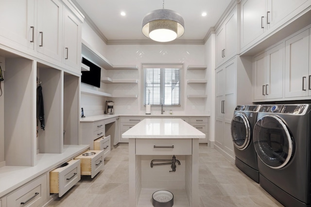 laundry area with independent washer and dryer, cabinet space, light tile patterned floors, ornamental molding, and recessed lighting
