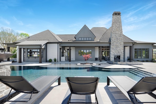 outdoor pool featuring a hot tub and a patio area