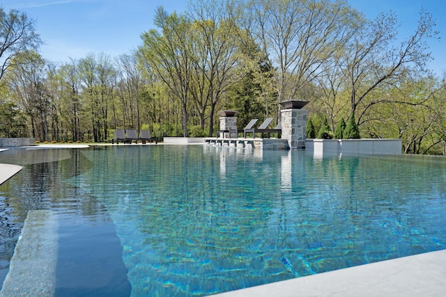 view of swimming pool featuring an infinity pool