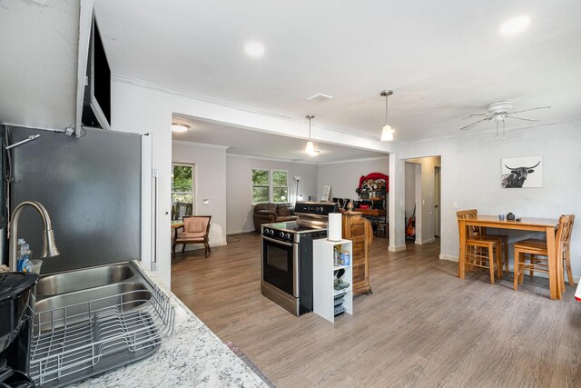 4051 New Highway 96 W, Franklin, TN 37064 - kitchen featuring appliances with stainless steel finishes, ornamental molding, light wood-style flooring, open floor plan, and a sink