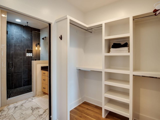 walk in closet with marble finish floor