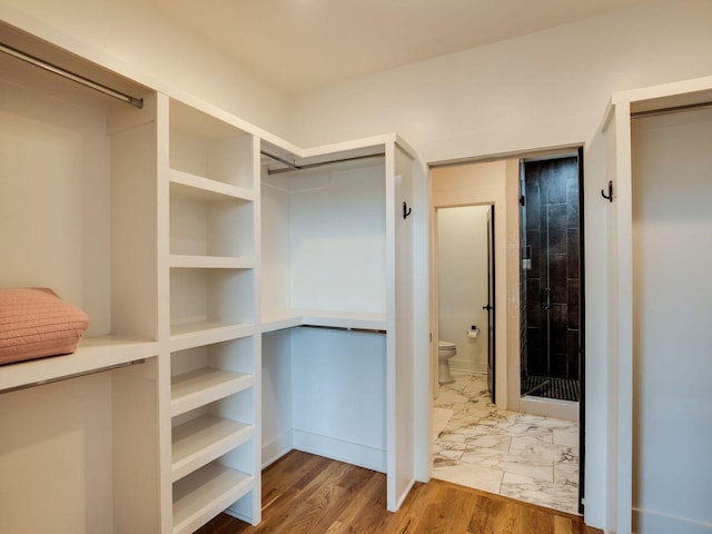 spacious closet with marble finish floor