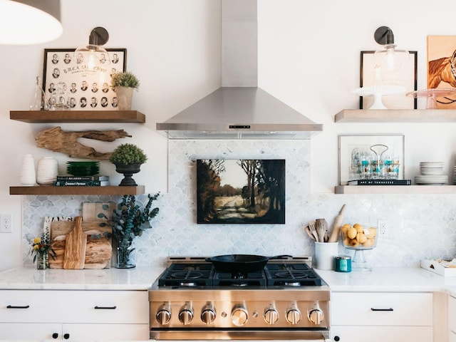 bar with backsplash, range, and wall chimney exhaust hood