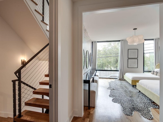 stairway featuring baseboards and wood finished floors