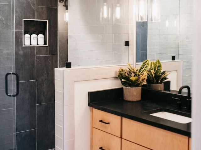 bathroom featuring vanity and a shower stall