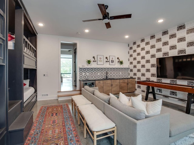 living area with a ceiling fan, recessed lighting, beverage cooler, and visible vents