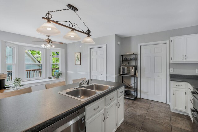 1077 Meandering Way, Franklin, TN 37067 - kitchen with white cabinets, a ceiling fan, dark countertops, and a sink