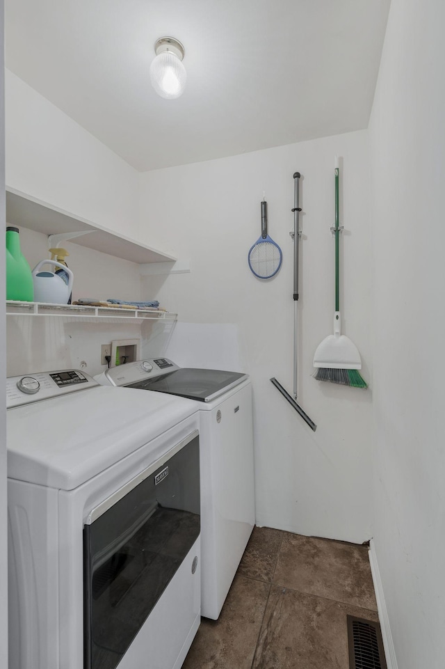 1077 Meandering Way, Franklin, TN 37067 - laundry room featuring visible vents, laundry area, stone finish flooring, and washing machine and clothes dryer