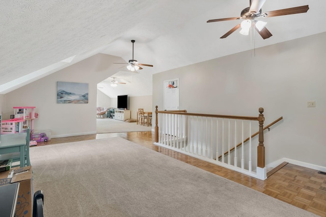 1077 Meandering Way, Franklin, TN 37067 - additional living space with visible vents, baseboards, ceiling fan, a textured ceiling, and vaulted ceiling