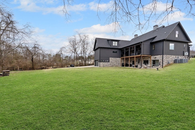 741 Saundersville Ferry Rd, Mount Juliet, TN 37122 - rear view of house with stone siding, a chimney, board and batten siding, an attached garage, and a yard