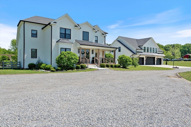 7314 Dug Hill Rd, Bon Aqua, TN 37025 - modern farmhouse featuring gravel driveway, a garage, covered porch, a standing seam roof, and a metal roof