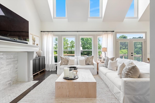 7314 Dug Hill Rd, Bon Aqua, TN 37025 - living room featuring high vaulted ceiling, healthy amount of natural light, a skylight, and french doors