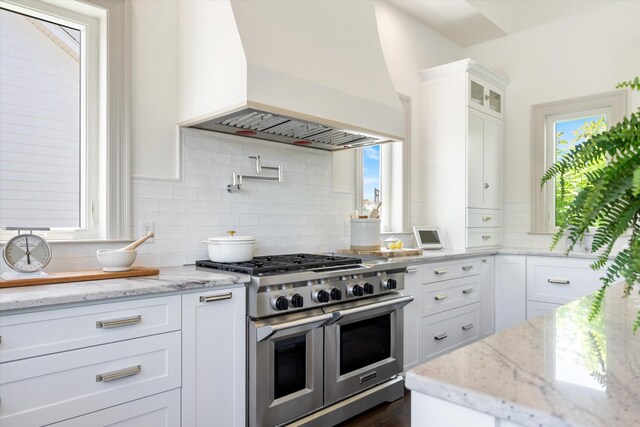 7314 Dug Hill Rd, Bon Aqua, TN 37025 - kitchen with premium range hood, double oven range, decorative backsplash, white cabinetry, and glass insert cabinets