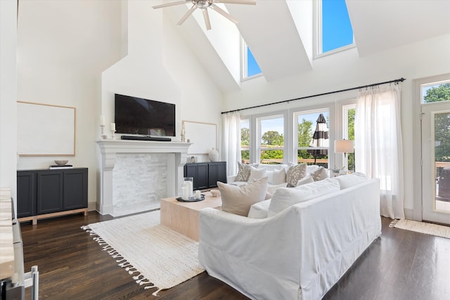 7314 Dug Hill Rd, Bon Aqua, TN 37025 - living area with high vaulted ceiling, a ceiling fan, dark wood-type flooring, a fireplace with flush hearth, and a skylight