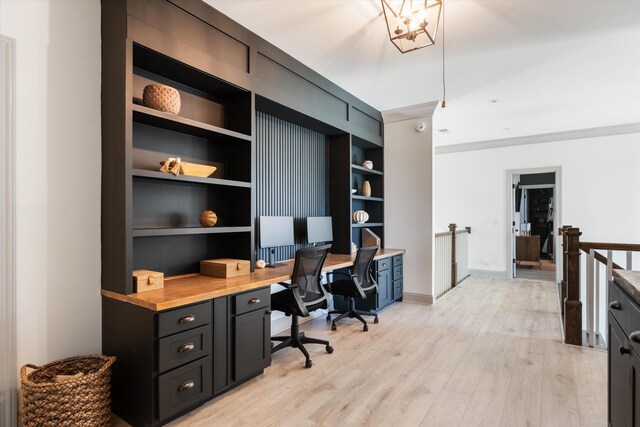 7314 Dug Hill Rd, Bon Aqua, TN 37025 - home office featuring light wood-style floors, built in shelves, built in study area, and ornamental molding