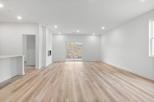 5060 Lawler Ln, Old Hickory, TN 37138 - unfurnished living room with light wood finished floors, baseboards, a glass covered fireplace, and recessed lighting