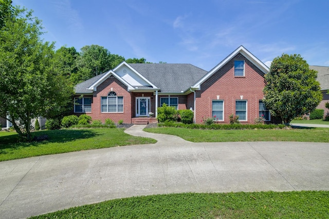 ranch-style house with brick siding and a front yard