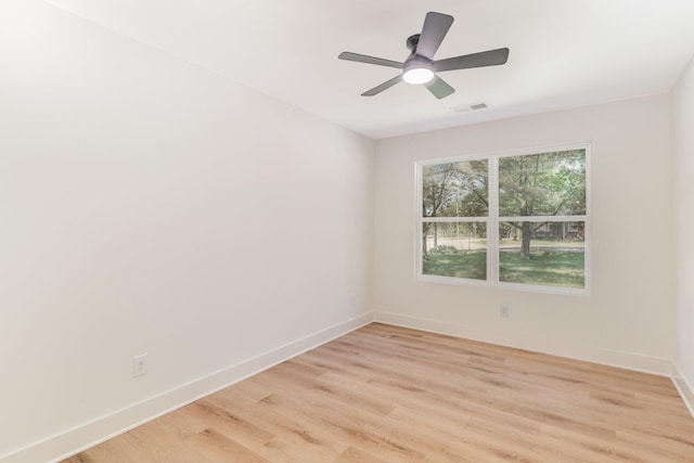 unfurnished room with visible vents, light wood-style flooring, ceiling fan, and baseboards