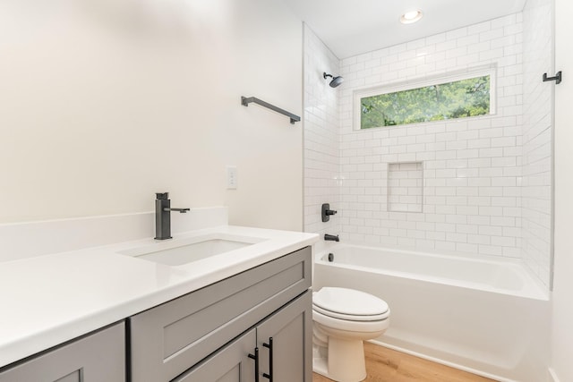full bath featuring wood finished floors, vanity, toilet, shower / bathtub combination, and recessed lighting