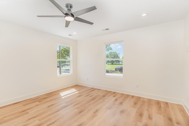 spare room with recessed lighting, baseboards, and light wood-style floors