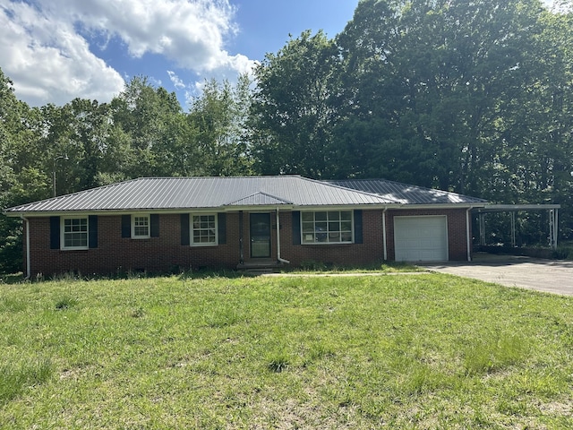 single story home with driveway, metal roof, a front lawn, and a garage