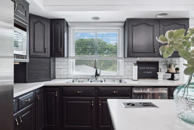 223 Kennett Rd, Old Hickory, TN 37138 - kitchen with light countertops, a sink, backsplash, and stainless steel appliances