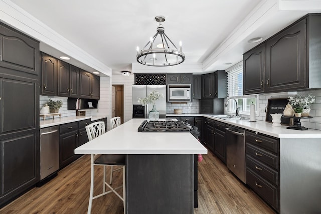 223 Kennett Rd, Old Hickory, TN 37138 - kitchen featuring dark wood-style flooring, appliances with stainless steel finishes, a sink, a breakfast bar area, and backsplash