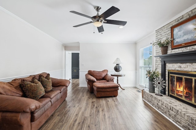 223 Kennett Rd, Old Hickory, TN 37138 - living room with crown molding, a fireplace, a wainscoted wall, a ceiling fan, and wood finished floors