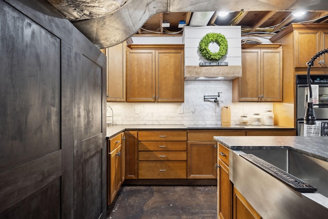 223 Kennett Rd, Old Hickory, TN 37138 - kitchen featuring decorative backsplash, concrete flooring, brown cabinets, and wall chimney exhaust hood