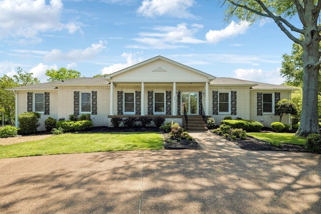 223 Kennett Rd, Old Hickory, TN 37138 - view of front of house with a porch, brick siding, and a front lawn