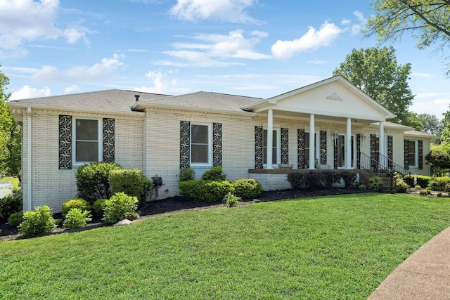 223 Kennett Rd, Old Hickory, TN 37138 - view of front of home featuring brick siding, roof with shingles, a front yard, and a porch