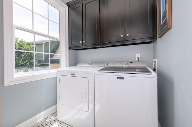 laundry room with cabinet space, baseboards, and washer and dryer