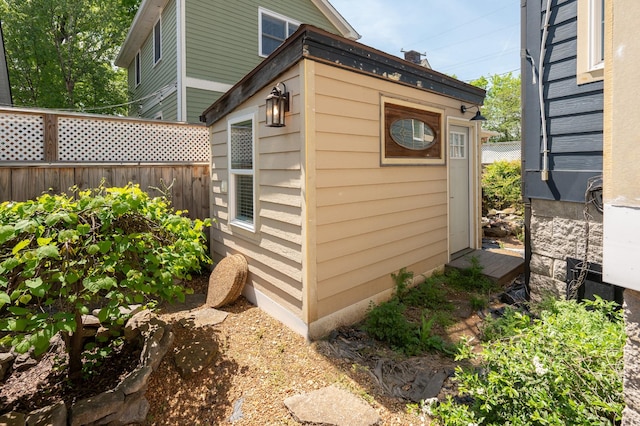 view of outbuilding with fence and an outdoor structure