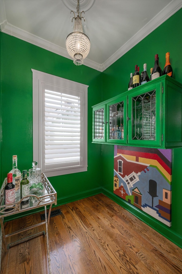 playroom featuring crown molding, a chandelier, and wood finished floors