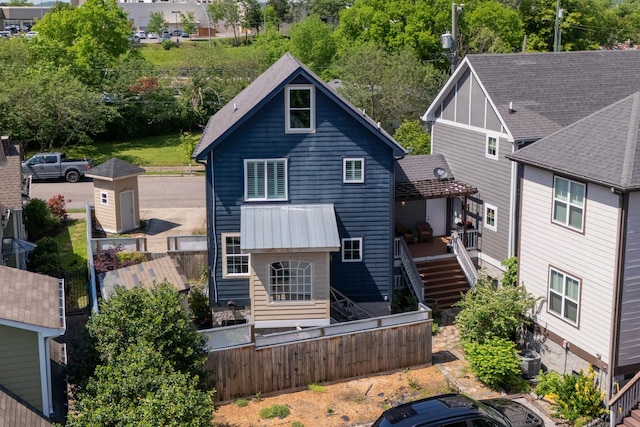 back of house featuring fence, a wooden deck, and cooling unit